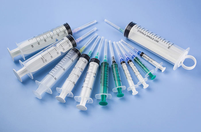  One-time use three-piece in-line syringe